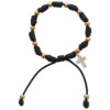 Bracelet dizainier sur corde réglable, de couleur noire, grains de couleurs dorés Ø 5 mm et croix blanche.