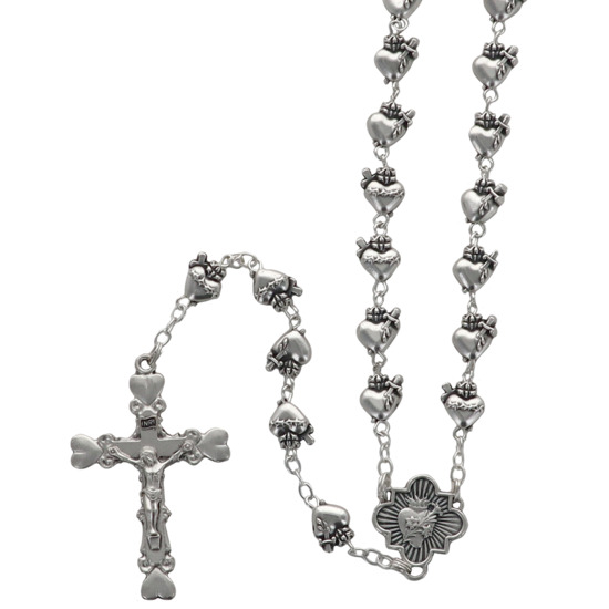 Chapelet métal de l'EX VOTO, grains Ø 8 mm sur chaîne de couleur argentée, longueur juqu'au coeur 40 cm, croix avec Christ. Livré en boîte.